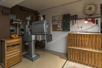 Cinema projectors by Zeiss Ikon around 1950 with film reel cabinets in a cinema projection room