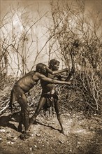 Two Bushmen hunting with bow and arrow
