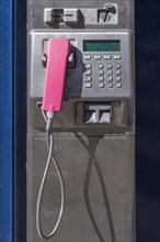 Public pay phone with pink handset