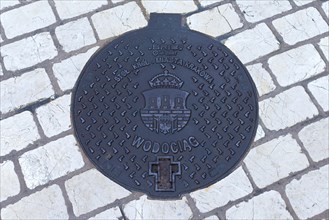 Manhole cover with city coat of arms of Krakow