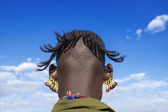 Man with four earrings in each ear