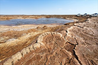 Salt lake with geothermal spring and petrified salt crystals