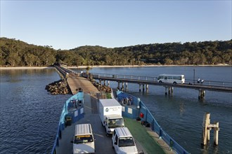 Kingfisher Bay ferry loaded with trucks and cars on the jetty of Fraser Island