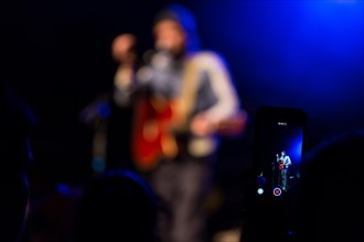 Concertgoer takes a photo with I-Phone at the concert of the Swiss singer and songwriter Shem Thomas live at the Schuur Lucerne