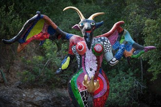 Colorful winged devil sculpture in the Giardino dei Tarocchi or Garden of the Tarot