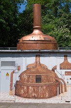 Old brewing kettle and mural at Stuttgarter Hofbrau brewery