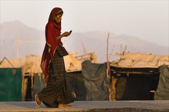 Afar Woman with cell phone in the Afar village of Ahmed Ale