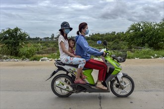 Two women with a child on a scooter