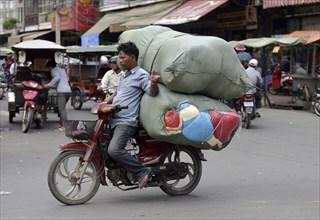 Man with moped and large sacks
