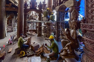 Craftsman carving wooden figures in the Sanctuary of Truth Temple