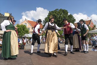 Folk dance group dancing in traditional costumes