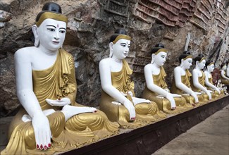 Line of Buddha statues at Kaw-goon Cave Temple