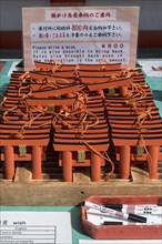 Ema wish plaques in the shape of orange torii gate