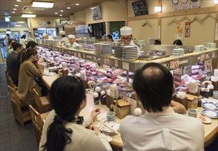 Kaiten-zushi restaurant serving sushi on rotating conveyor belt
