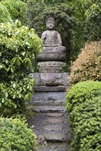 Buddha statue in garden of Ryoanji