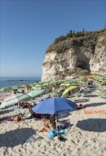 Many people with colorful sunshades at Lido Isola Bella Beach