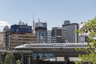 Shinkansen bullet train on a bridge in Shiodome