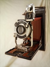 Old Kodak Brownie folding camera with red bellows and Koilos shutter
