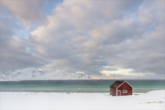 Rorbuer fishing hut on the beach in the snow