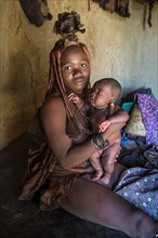 Himba woman holding her baby