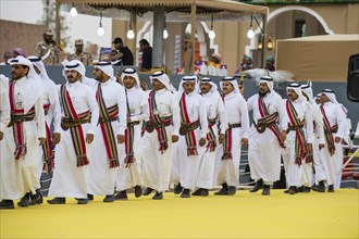 Traditional dressed local men dancing at the Al Janadriyah Festival