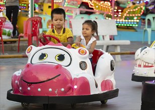 Children driving bumper cars in Koh Pich theme park