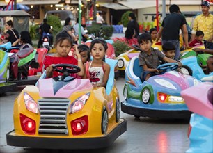 Children driving scooters at Koh Pich theme park