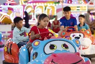 Children driving bumper cars at Koh Pich theme park