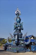 Demon sculpture at the entrance of Wat Rong Seur Ten