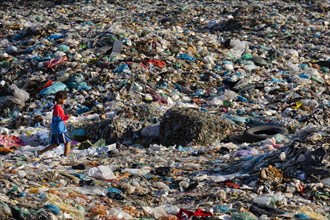 Little girl in garbage dump