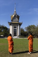 Buddhist monks in front of the Memorial Stupa
