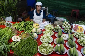 Seller with fresh vegetables