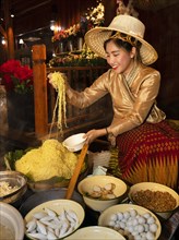Young woman preparing a noodle soup