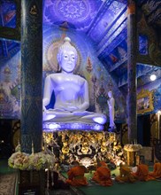 Monks in front of the blue Buddha statue of Wat Rong Seur Ten