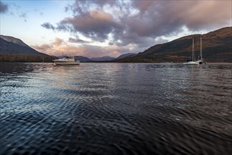 Boats with Loch Linnhe at sunrise with coloured clouds