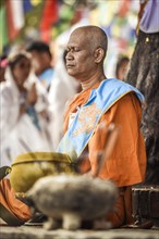Buddhist master meditates on the Bodhi tree at the Mayadevi temple