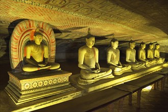 Buddha statues and murals in one of the cave temples of the Golden Temple