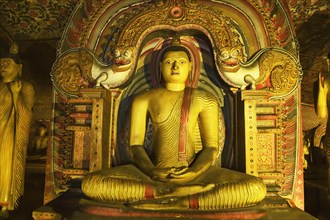 Buddha statue and murals in one of the cave temples of the Golden Temple