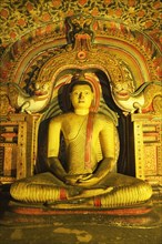 Buddha statue and murals in one of the cave temples of the Golden Temple