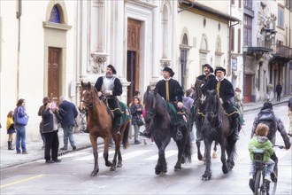 Participants in historical clothing riding on horses