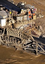 Two men near conveyor belt