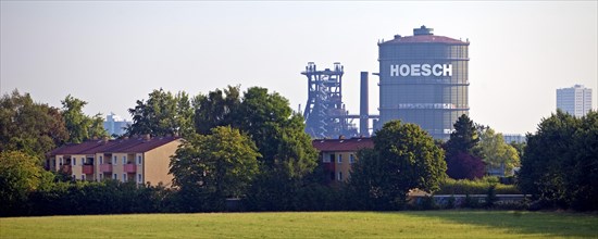 Apartment blocks in front of the Hoesch Gasometer and the blast furnace in the Horde district