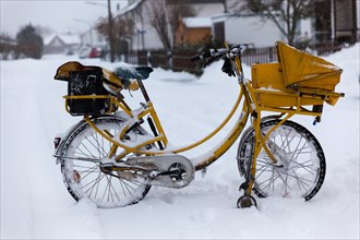 Yellow post bike in the snow