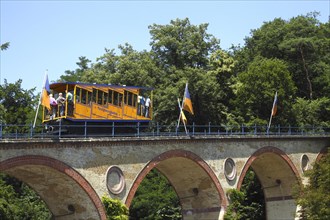 Waggon of Nerobergbahn drives over arch bridge