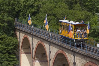 Waggon of Nerobergbahn drives over arch bridge