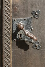 Old doorknob on wooden house door