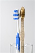 Toothbrushes made of plastic and wood in glass