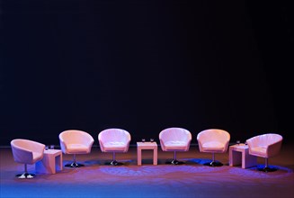 Podium with empty armchairs on a stage