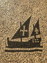 Mosaic of a historic sailing ship with cobblestones near Sanat Cruz