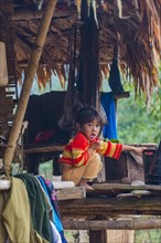 Young girl sitting in a hut